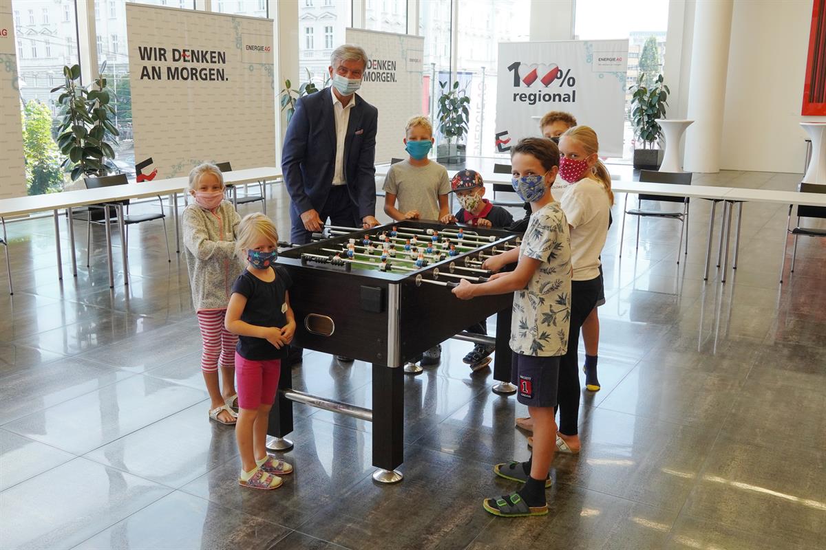 Generaldirektor am Wuzzlertisch mit den Kindern der Ferienaktion